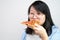 Happy glasses Asian young woman eat Pizza on white background