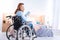 Happy good-looking smiling paralyzed woman holding a book