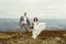 Happy gorgeous bride and stylish groom jumping and having fun, b