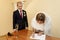 Happy gorgeous bride and stylish groom signing official document