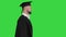 Happy graduate male student walking on a Green Screen, Chroma Key.