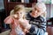 Happy grandfather and cute little toddler granddaughter, adorable child eating together ice cream. Family tasting sweet