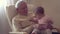 Happy grandfather holds a baby on hands indoors generation happiness concept slow motion