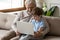 Happy grandfather and small grandson use computer