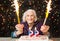 Happy grandma celebrating 99th birthday with firework