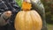 Happy grandma and girl cutting pumpkin for Thanksgiving pie, holiday traditions