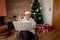 Happy grandma receiving christmas message by video call