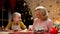 Happy grandmother and girl smiling, pleased with Christmas baking, holidays