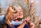 Happy grandmother with granddaughter together outdoors. Grandchild hugs  beloved grandmother, happy autumn or spring time