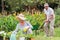 Happy grandmother and grandfather gardening