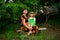 Happy grandmother and little granddaughter sitting in park