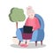 Happy grandmother sits in a chair at a laptop