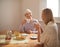 Happy, grandmother and tea in home with woman at brunch bonding on visit in retirement. Senior, grandma and girl on