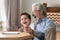 Happy grandparent enjoy drawing in album with grandson