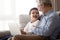 Happy grandparent and grandson have fun using laptop together