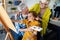 Happy grandparents and granddaughter drawing, painting together