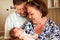 Happy grandparents with newborn baby