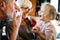 Happy grandparents playing with their little cute granddaughter