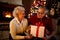 Happy grandparents smiling and holding big gift