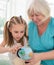 Happy granny showing globe to granddaughter