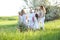 Happy granny standing with daughters, granddaughters and grand granddaughter outside.