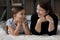 Happy granny and teen granddaughter relax together