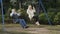 Happy gray-haired man with adult daughter swings on teeterboard