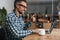 Happy grey man showing thumb up while taking conference call on laptop