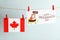 Happy Groundhog Day greeting card and Canada flag hanging against light background