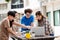 Happy Group of attractive young people using a laptop and tutoring together on study table, Social media online concept and Youth