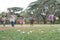 Happy group of diverse cute little children hunting Easter eggs, wearing bunny ears. kids holding basket, running to collect eggs