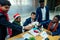 Happy group of indian and african american people drinking toast from cup,wearing santa hat and tinsel