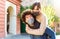 Happy group of a latino curly man and a brunette woman wearing protective face mask after lockdown reopening.young couple in a