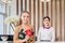 Happy guest and receptionist at hotel reception, Young travellers standing at reception desk with blurred female receptionist