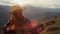 Happy guitarist smiling outdoors in mountains closeup. Joyful girl play guitar.