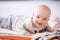 Happy gurgling baby lying on his bed