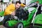 Happy guy deciding on best lawnmower in garden equipment shop