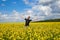 Happy guy enjoying life without pollen allergy in a rapeseed field