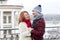 Happy guy looks to woman. Urban couple date on bridge. Red hair woman meet smiling guy. woman and laughing men on city background