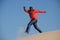 Happy guy running down dune