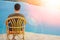 Happy guy sitting on a stool by the sea background on the nature