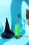 Happy Halloween, bottles with green cocktail, witch hat, mystical decor on a bright background