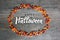 Happy Halloween Calligraphy With Candy Corn Oval Border Over Rustic Wooden Background, Horizontal