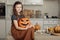 Happy halloween. Cute little girl in witch costume with carving pumpkin. Happy family preparing for Halloween