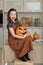 Happy halloween. Cute little girl in witch costume with carving pumpkin. Happy family preparing for Halloween