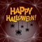 Happy Halloween with dangling spiders and spooky spider web frame.