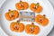 Happy Halloween day with funny Cookies, different Pumpkin biscuits on plate. Trick or Threat, Hello October, fall autumn,