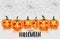 Happy Halloween design with orange pumpkins with glowing faces and spider web on the background.