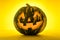 Happy Halloween. Funny glowing pumpkin Jack-o-lantern on a yellow background.