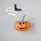 Happy halloween. Funny halloween pumpkin with speech bubble and bat on gray background